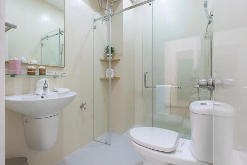 a bathroom with a toilet and a sink and a shower at Simone's Shophouse - Not a hotel in Ho Chi Minh City
