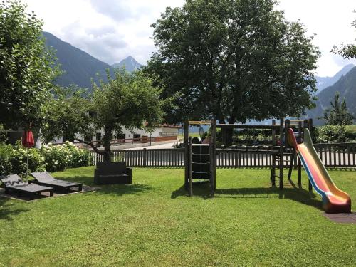 a playground in a park with a slide at derNeuwirt in Schwendau
