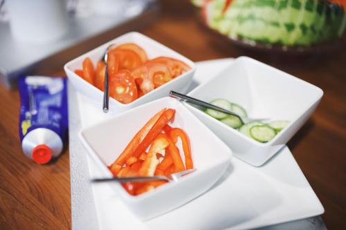 two white bowls of food on a table at City Central Hotel Örebro by First Hotels in Örebro