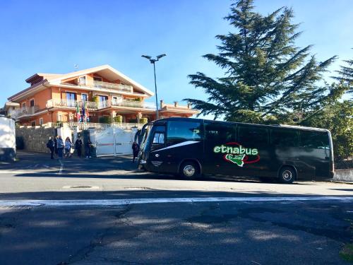 a black bus parked on the side of a street at Etna Royal View in Trecastagni