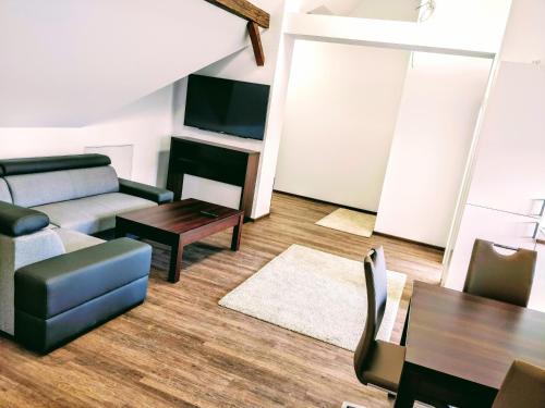 a living room with a couch and a table at Aparthotel - Stadtvilla Premium in Schweinfurt