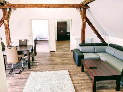 a living room with a couch and a table at Aparthotel - Stadtvilla Premium in Schweinfurt