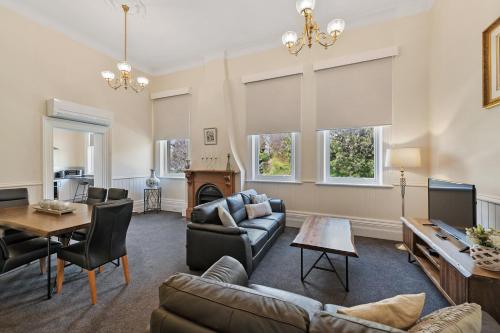 a living room with a couch and a table at Waratah On York in Launceston