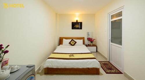 Postel nebo postele na pokoji v ubytování An Phu Hotel Da Lat