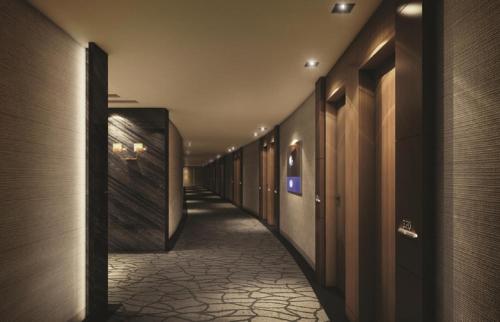 a hallway of a hotel with wooden walls and a tile floor at Jeongseon JS GRAND PALACE Hotel in Jeongseon