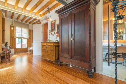a room with a wooden cabinet and a dining room at Miraclet - ADULTS ONLY in Palma de Mallorca