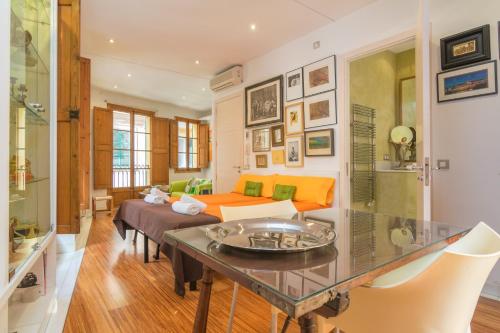 a living room with a table and a couch at Miraclet - ADULTS ONLY in Palma de Mallorca