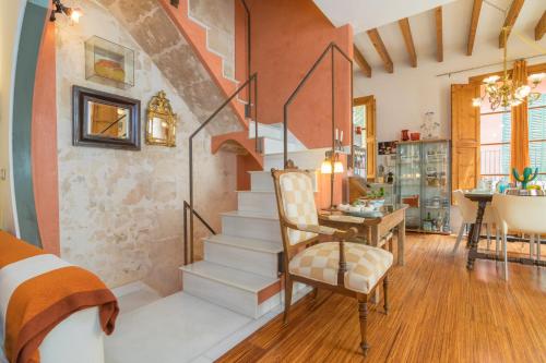 a room with a staircase and a table and chairs at Miraclet - ADULTS ONLY in Palma de Mallorca
