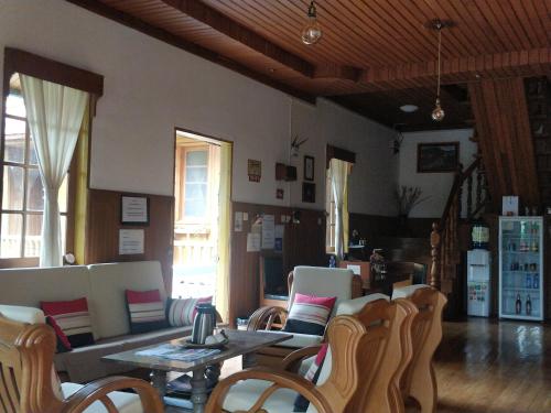 a living room with a table and chairs at Hillock Villa in Kalaw