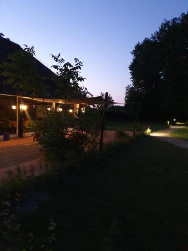 a house at night with the lights on at Schaluinenhoeve in Baarle-Nassau