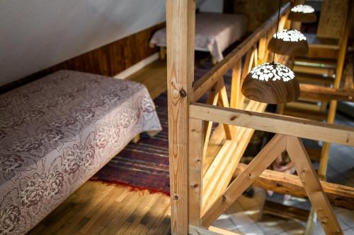 a room with a bed and a wooden staircase at Erlendi Kodumajutus in Pärnu