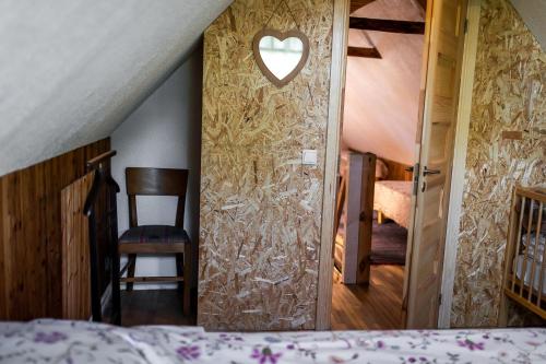 a bedroom with a door with a heart cut into the wall at Erlendi Kodumajutus in Pärnu