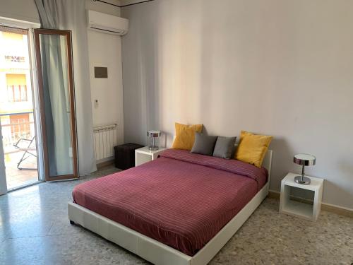 a bedroom with a large bed with a red blanket at Sorrento Soul in Sorrento