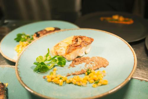 a plate of food with corn on a table at Brandon House Hotel in New Ross