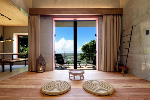 a living room with a view of the ocean at Kaiza in Nanjo