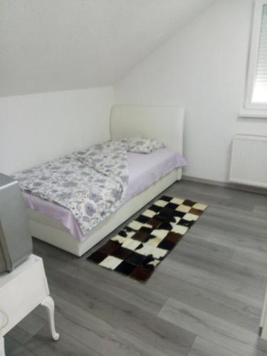 a bedroom with a bed and a checkered floor at Apartman All seasons in Sarajevo