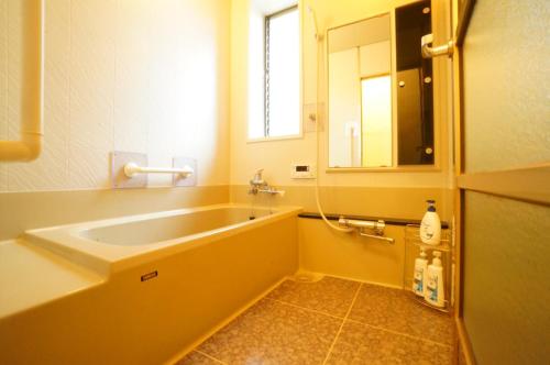 La salle de bains est pourvue d'un grand lavabo et d'un miroir. dans l'établissement Takayama - House / Vacation STAY 34422, à Takayama