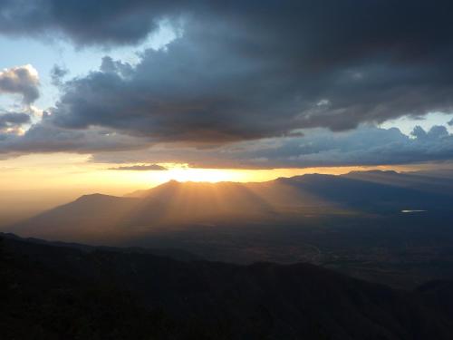 a view of the sun setting over a mountain range at Mambo View Point in Ndungu