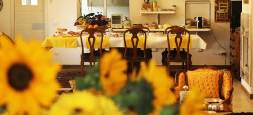 a kitchen with a table with a yellow table cloth at Le Ginestre in Massa
