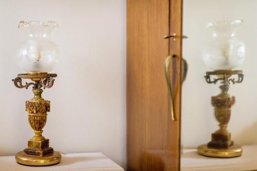 a pair of lamps on a table next to a mirror at Kiko, the Coastline house in Kato Achaia