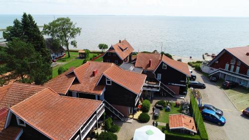 an overhead view of a row of houses with orange roofs at Vila Baldininkas in Neringa