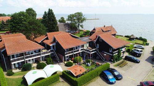 an aerial view of a house with cars parked in a parking lot at Vila Baldininkas in Neringa