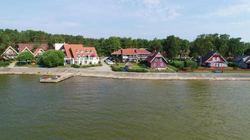 a group of houses next to a body of water at Vila Baldininkas in Neringa