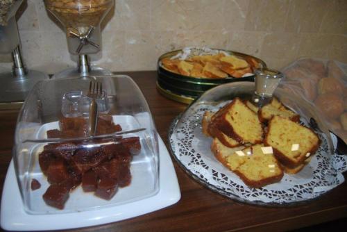 a table with a plate of food and a plate of bread at Hotel Arangues in Setúbal