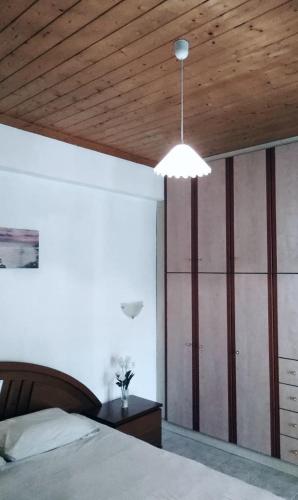 a bedroom with a bed and a wooden ceiling at Villa Thanos in Marathias