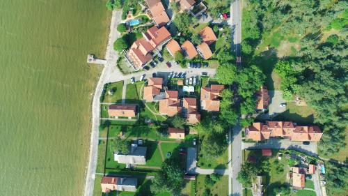 a group of houses in a yard next to a river at Vila Baldininkas in Neringa