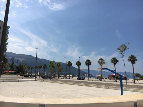 ein Basketballplatz auf einem Parkplatz mit Palmen in der Unterkunft MiMi's Beach Apartment in Vlorë