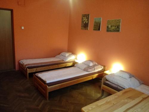 three beds in a room with lights on them at Pokoje Gościnne Monika Szling in Zakopane