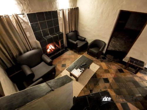 an overhead view of a living room with a fireplace at Umuzi Lodge in Secunda