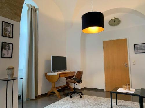 a room with a desk with a computer on it at Wohnen in ehemaligen Kloster in Lichtenfels