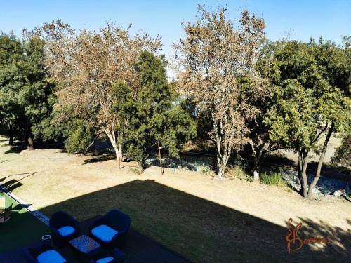 an aerial view of a park with trees and grass at Umuzi Lodge in Secunda