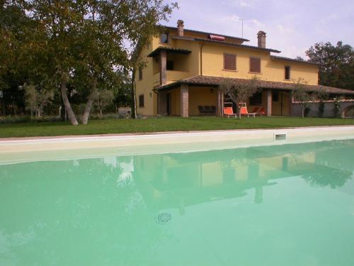 a house and a swimming pool in front of a house at Casavacanze Sant'Eugenia in Attigliano