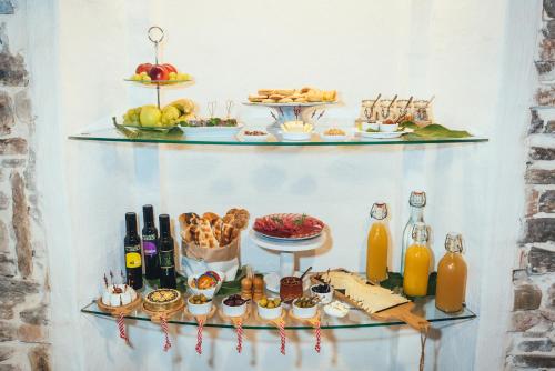 a buffet of food and drinks on shelves at Guesthouse Centrum B&B in Izola