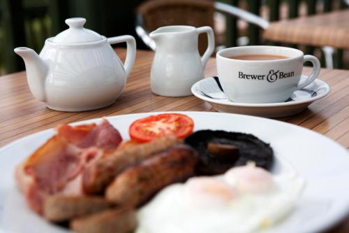 a plate of food and a cup of coffee on a table at County Arms in Truro