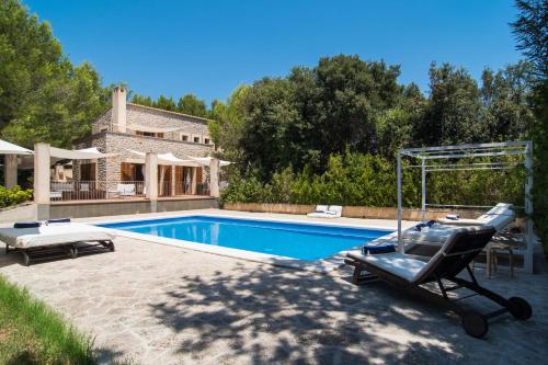 una piscina en un patio trasero con una casa en Villa Pula Golf by Priority, en Son Servera