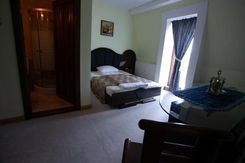 a bedroom with a bed and a window at Saciova Hills in Saciova
