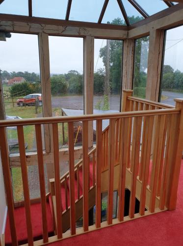 a view of a porch with a wooden railing at the old red lion in Bruton