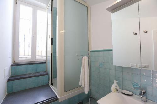 a bathroom with a sink and a glass shower at Casa Ponticeto in Ravello