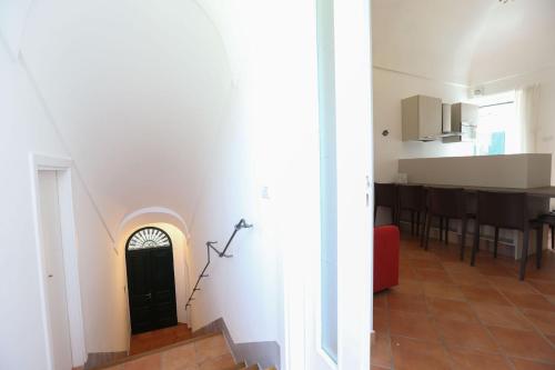 a living room with a door in the wall at Casa Ponticeto in Ravello