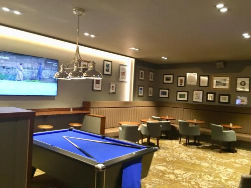 a restaurant with a pool table and a tv at The Station Hotel in Aberdeen