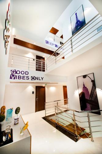 a room with a staircase and a sign that reads good vibes only at Raj Residency in Bengaluru
