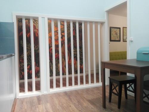 a dining room with a table and a fence at Casa da Varanda Verde in Vila Real