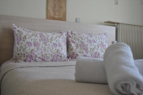 a bed with purple and white pillows at Alexander Apartments in Alexandroupoli