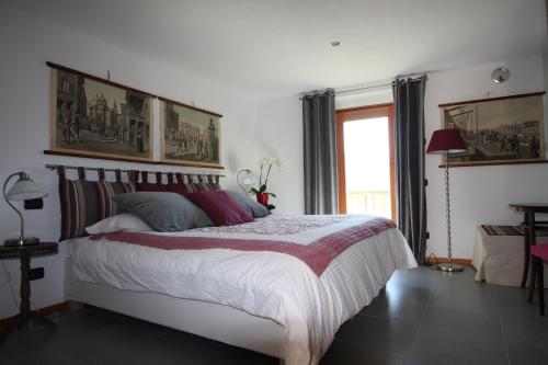 a bedroom with a large bed and a window at Maison Perriere - Chambres d'hôtes & Jacuzzi in Saint Vincent