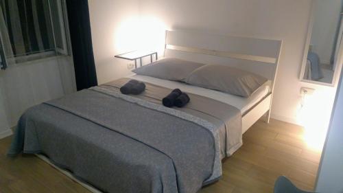 a bedroom with a large bed with two bags on it at Studio apartman Adris in Šibenik