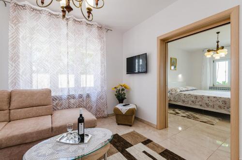 a living room with a couch and a bed at Apartmani Katica in Povile